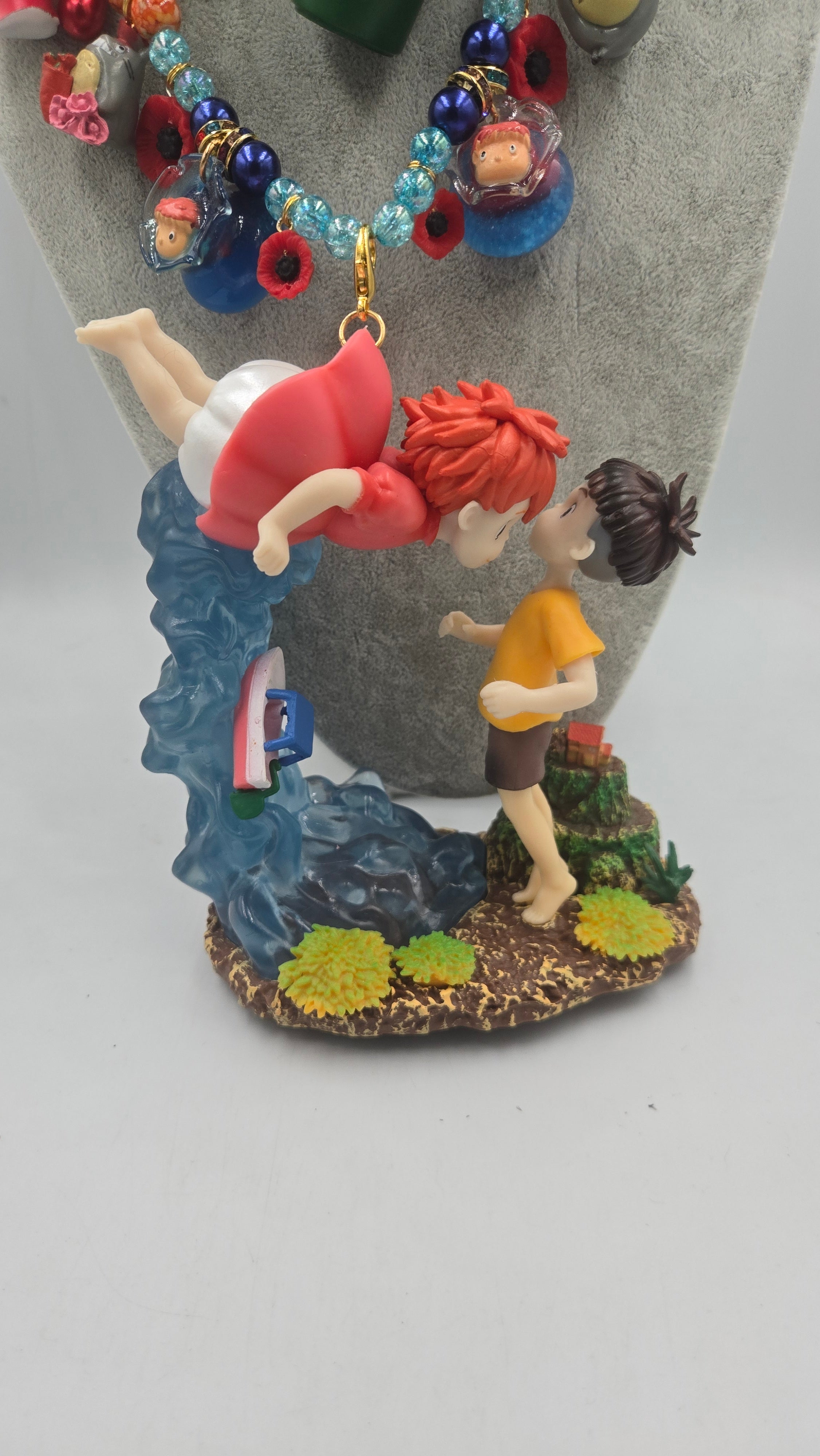 Sosuke and Ponyo on a cliff by the sea