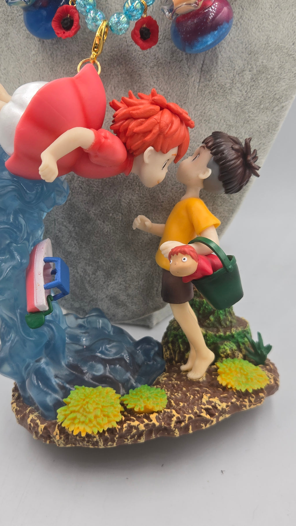 Sosuke and Ponyo on a cliff by the sea