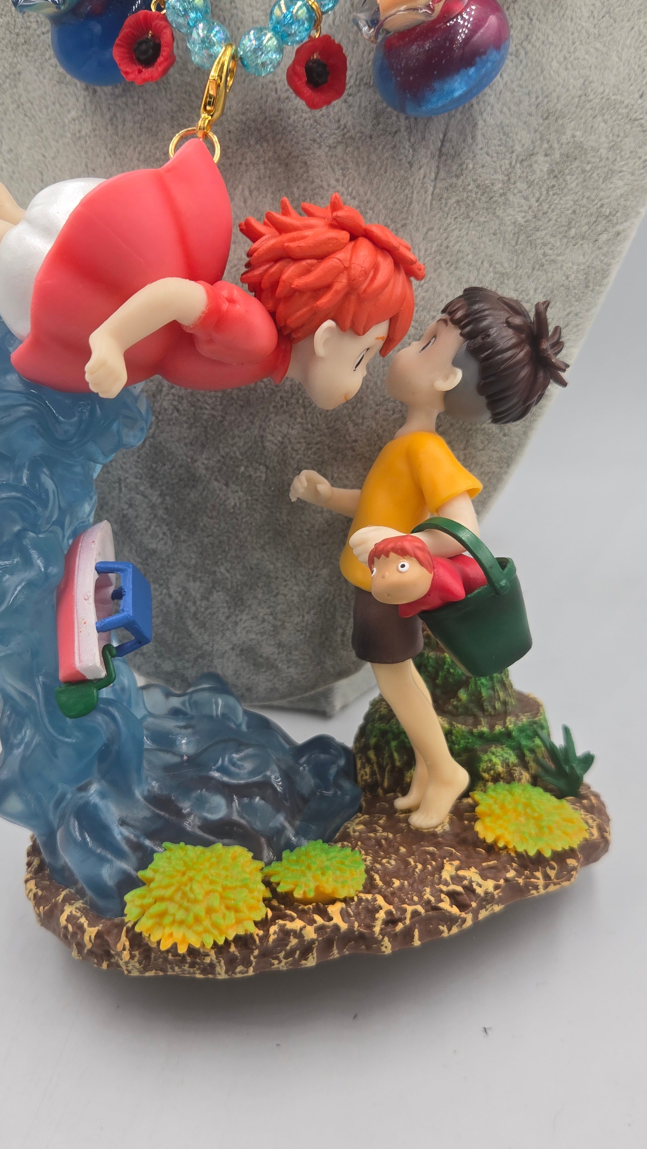 Sosuke and Ponyo on a cliff by the sea