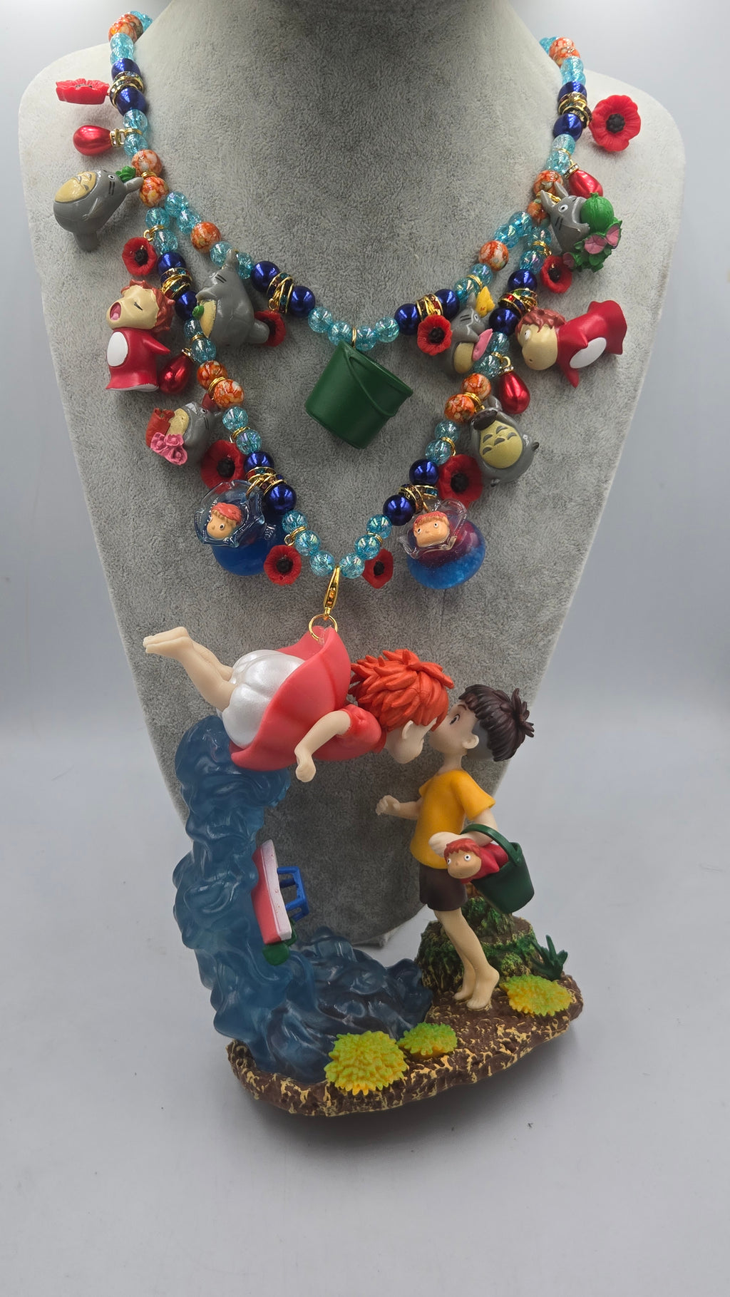Sosuke and Ponyo on a cliff by the sea